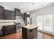 Modern kitchen with stainless steel appliances, granite countertops, and hardwood floors at 103 Ballyliffen Ln, Cary, NC 27519