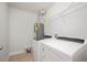 Bright laundry room features modern washer, dryer, and water heater at 103 Ballyliffen Ln, Cary, NC 27519