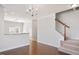 Inviting living room with hardwood floors, open layout, and staircase access at 103 Ballyliffen Ln, Cary, NC 27519