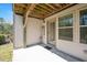 A covered patio features exposed beams and a view of the backyard at 103 Ballyliffen Ln, Cary, NC 27519