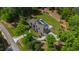 Estate aerial view featuring a pool, meticulous landscaping, and a winding driveway at 103 Patriot Way, Apex, NC 27523