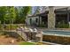 Stunning backyard boasts a luxurious pool, outdoor lounge area, and lush landscaping at 103 Patriot Way, Apex, NC 27523