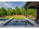 Beautiful backyard features a spa with spillover into the pool, offering a serene outdoor experience at 103 Patriot Way, Apex, NC 27523