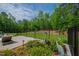 Scenic backyard featuring manicured landscaping, a fence, and cozy outdoor seating for ultimate relaxation at 103 Patriot Way, Apex, NC 27523