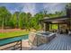 Beautiful backyard with stone spa, pool, covered patio, fireplace and lush landscaping at 103 Patriot Way, Apex, NC 27523