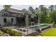 Backyard featuring a pool, lounge chairs, landscaped yard, stone fireplace, and outdoor living at 103 Patriot Way, Apex, NC 27523