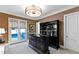 A sophisticated bar room with custom built-ins, elegant lighting, and direct access to the outdoor area at 103 Patriot Way, Apex, NC 27523