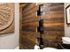 Unique bathroom with wood plank door and walls and exposed storage at 103 Patriot Way, Apex, NC 27523