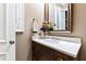Bathroom with marble countertop and dark wood cabinets and stylish faucet and hardware at 103 Patriot Way, Apex, NC 27523