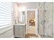 Modern bathroom with marble counter tops, a glass shower and great natural light at 103 Patriot Way, Apex, NC 27523