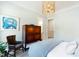 Inviting bedroom featuring an elegant gold chandelier and a cozy chair, complementing the room's soothing color palette at 103 Patriot Way, Apex, NC 27523