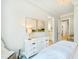 Serene bedroom features dresser, serene artwork, and an open en suite bathroom and staircase at 103 Patriot Way, Apex, NC 27523