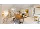 Bright and airy bonus room with a large table, built-in storage, and staircase access at 103 Patriot Way, Apex, NC 27523