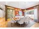 Elegant dining room features a wine cellar, modern chandelier, and large windows at 103 Patriot Way, Apex, NC 27523