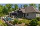 Stunning outdoor view showcasing a well-manicured lawn, a private pool, and a screened porch at 103 Patriot Way, Apex, NC 27523