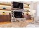 Beautiful stone fireplace features a mantle, tv, and unique storage with recessed lighting at 103 Patriot Way, Apex, NC 27523