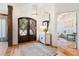 Inviting foyer featuring a decorative front door, stylish lighting, and a view into a cozy sitting area at 103 Patriot Way, Apex, NC 27523