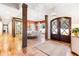 Grand foyer featuring hardwood floors, decorative columns and a stunning view of the formal dining and living spaces at 103 Patriot Way, Apex, NC 27523
