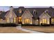 A beautifully crafted stone home featuring a front entrance with an elegant, oversized wooden door at 103 Patriot Way, Apex, NC 27523