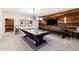 Finished basement game room with pool table, shuffleboard and rustic wood accent wall at 103 Patriot Way, Apex, NC 27523