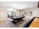 Game room with a pool table, shuffleboard, and seating area, designed for entertainment and relaxation at 103 Patriot Way, Apex, NC 27523
