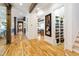 Inviting hallway featuring hardwood floors, detailed trim work, and an open layout to the rest of the home at 103 Patriot Way, Apex, NC 27523