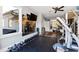 Home gym featuring an expansive mirror, varied exercise equipment, and a ceiling fan at 103 Patriot Way, Apex, NC 27523
