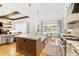 Bright kitchen boasts stainless steel appliances, center island, and access to the dining room at 103 Patriot Way, Apex, NC 27523