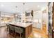 Elegant kitchen with a large center island, stainless steel appliances, and hardwood flooring throughout at 103 Patriot Way, Apex, NC 27523