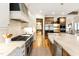 Gourmet kitchen with high-end stainless-steel appliances, a spacious island, and ample cabinet space for storage at 103 Patriot Way, Apex, NC 27523