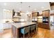 Modern kitchen with stainless appliances, large island, and custom cabinets with accent lighting at 103 Patriot Way, Apex, NC 27523