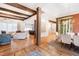 Bright and spacious living and dining areas with hardwood floors, exposed beams, and a view of the gourmet kitchen at 103 Patriot Way, Apex, NC 27523