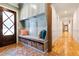 Cozy mudroom features a built-in bench, storage cubbies, and a coat rack for easy organization of outerwear and accessories at 103 Patriot Way, Apex, NC 27523