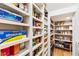 Spacious walk-in pantry with ample shelving for organized storage of food items and household goods at 103 Patriot Way, Apex, NC 27523