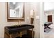 A powder room featuring a modern black sink with gold finishings, and a decorative mirror above at 103 Patriot Way, Apex, NC 27523