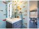 Unique powder room featuring quirky fish-themed wallpaper, modern vanity, and access to the covered porch at 103 Patriot Way, Apex, NC 27523