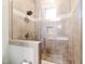 A fully tiled shower with glass door and window, showcasing neutral earth tones and chrome finishings at 103 Patriot Way, Apex, NC 27523