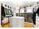 Walk-in closet with custom shelving, drawers, and a central island for storage at 103 Patriot Way, Apex, NC 27523