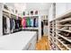 Bright walk-in closet features custom organization with shelves, drawers, and hanging spaces at 103 Patriot Way, Apex, NC 27523