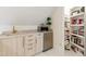Wet bar area with sink, beverage refrigerator and shelving and open closet at 103 Patriot Way, Apex, NC 27523