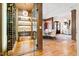 Custom wine cellar with glass doors, wooden racks, and a temperature-controlled environment for wine storage at 103 Patriot Way, Apex, NC 27523