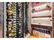 Walk-in wine cellar featuring floor-to-ceiling wine racks and custom wood shelving for a curated collection at 103 Patriot Way, Apex, NC 27523