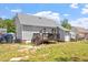Backyard featuring a house with gray siding, a wooden deck, and a fenced-in grassy yard at 106 Northwinds Dr, Wendell, NC 27591