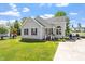 Charming single-story home with gray siding and a well-manicured lawn and driveway at 106 Northwinds Dr, Wendell, NC 27591