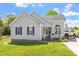 Charming single-story home with gray siding and brick accents on a well-manicured lawn at 106 Northwinds Dr, Wendell, NC 27591