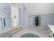 Charming attic storage space featuring blue walls, carpeted floor, and convenient clothing rack with garments at 107 Oxford Creek Rd, Cary, NC 27519