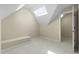 Attic bonus room with dormer and skylight shows neutral carpet and a painted bench seat at 107 Oxford Creek Rd, Cary, NC 27519