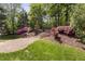 Backyard with landscaping, retaining wall, stairs, grass, and a retaining wall at 107 Oxford Creek Rd, Cary, NC 27519