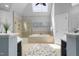 Well-lit bathroom boasting a skylight, tiled shower, and a luxurious soaking tub at 107 Oxford Creek Rd, Cary, NC 27519