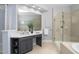 Well-lit bathroom featuring double vanity and a frameless glass shower at 107 Oxford Creek Rd, Cary, NC 27519